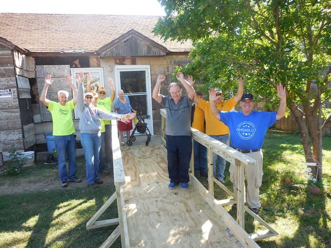 Diane Roach, 62, celebrates with Texas Ramp Project volunteers Saturday after receiving an access ramp.