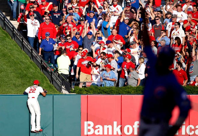St. Louis Cardinals' Jason Heyward (22) watches as Chicago Cubs' Jorge Soler two-run home run lands in the stands during the second inning of Game 2 in baseball's National League Division Series Saturday, Oct. 10, 2015, in St. Louis. Dexter Fowler, right, scored on the home run. (AP Photo/Charles Rex Arbogast)