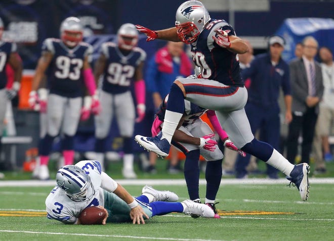 New England Patriots' Malcom Brown jumps over Dallas Cowboys quarterback Brandon Weeden after he was stopped during the second half of an NFL football game, Sunday, Oct. 11, 2015, in Arlington, Texas.