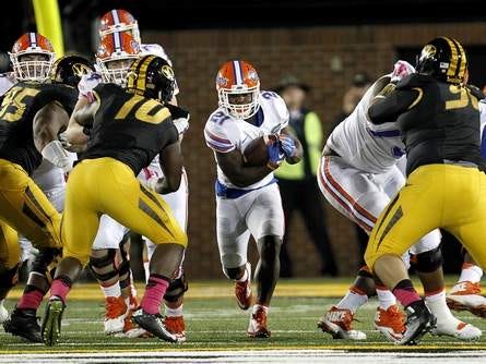 Florida running back Kelvin Taylor (21) picks up yardage Saturday against Missouri during the second half at Faurot Field in Columbia, Mo. Florida defeated Missouri 21-3. Taylor finished with 99 yards rushing and two touchdowns.