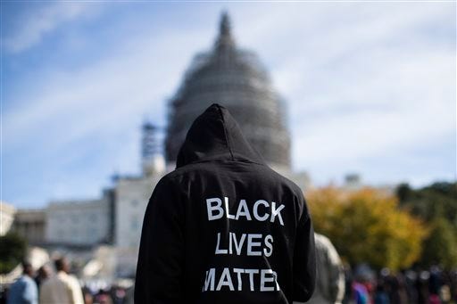 Neal Blair, of Augusta, Ga., wears a hoodie which reads, "Black Lives Matter" as stands on the lawn of the Capitol building during a rally to mark the 20th anniversary of the Million Man March, on Capitol Hill, on Saturday, Oct. 10, 2015, in Washington. Black men from around the nation returned to the capital calling for changes in policing and in black communities. (AP Photo/Evan Vucci)