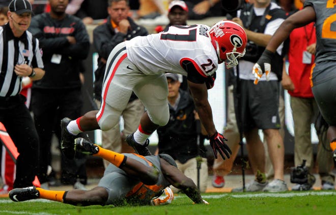 Wade Payne/The Associated PressGeorgia running back Nick Chubb (27) is tackled by Tennessee defensive back Emmanuel Moseley (12) on Saturday during a game in Knoxville, Tenn. Chubb was injured on the play.
