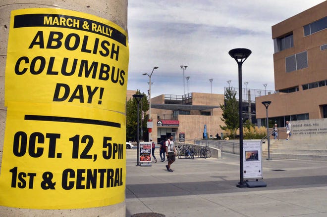 In this Sept. 21, 2015, photo, a flyer on the campus of the University of New Mexico in Albuquerque calls for students to join a protest against Columbus Day. Monday, Oct. 12, 2015, marks the annual Columbus Day nationwide, but in a twist that signals a growing trend, it will also be Indigenous Peoples Day in at least nine U.S. cities this year. (AP Photo/Russell Contreras)