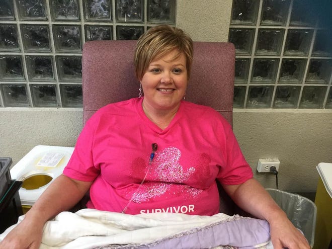 Stuart W. Cramer High Assistant Principal Dawn Lavinder receives her first maintenance treatment after six full chemotherapy treatments. She is wearing the survivor shirt that cancer survivors receive when they participate in the Susan G. Komen Race for the Cure.