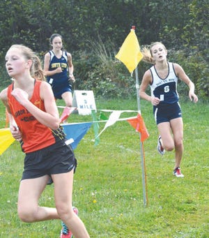 Ellie Fleming of Harbor Springs, left, leads Megan Arbic of Sault High and Emily Hudgens of South Lyon as they make the final turn before heading to the finish line at the 19th annual Sault Elks Invitational cross country event Saturday. Arbic moved up to finish second in the race, while Fleming was third. Harbor Springs was the top team finisher.