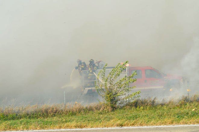 Mary Ann Dybdal, who lives on Pine Tree Court east of the Kewanee Dunes golf course, took this photo of Galva firefighters battling a field fire near the country club Monday.