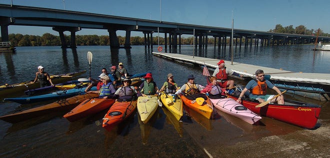 Protesting kayakers join hands before heading out from Bordentown Beach in Bordentown City toward Public Service Electric & Gas' Mercer Generating Station along the Delaware River on Monday, Oct. 12, 2015. The participants object to what they are calling major impacts to aquatic life and the river's ecosystem.