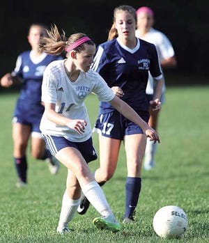 New Jersey Herald photo by Jake West/Sparta's Kelly Carolan gives the ball a boot during Tuesday's game against Morris Knolls at Sparta High School. Carolan scored twice for the Spartans.