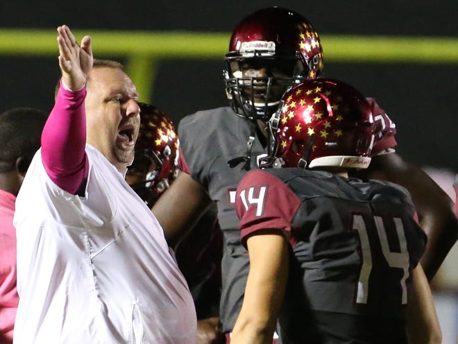 North Marion's head coach Stephen Field works with his team during their 37-0 win over Lake Worth on Friday in Sparr.