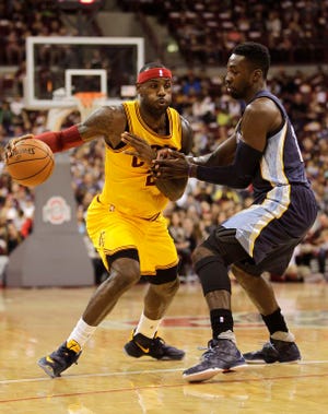 Cavaliers forward LeBron James (left) drives to the basket against the Grizzlies’ Jeff Green during the first quarter of Monday’s preseason game in Columbus. Memphis won 91-81.