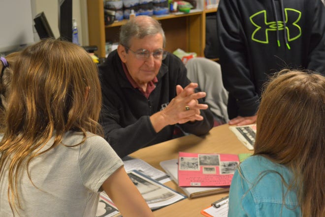 Korean War veteran Ezio Fiacco speaks as students from Linda Walter's sixth-grade technology classes listen during an interview at the Hornell Intermediate School library Tuesday. RYAN PAPASERGE/THE EVENING TRIBUNE