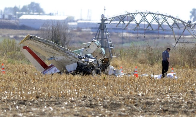 Emergency responders sift through the wreckage of a plane after a crash killed two on Oct. 13 east of Ault, Colo. The investigation into why the plane crashed is ongoing.