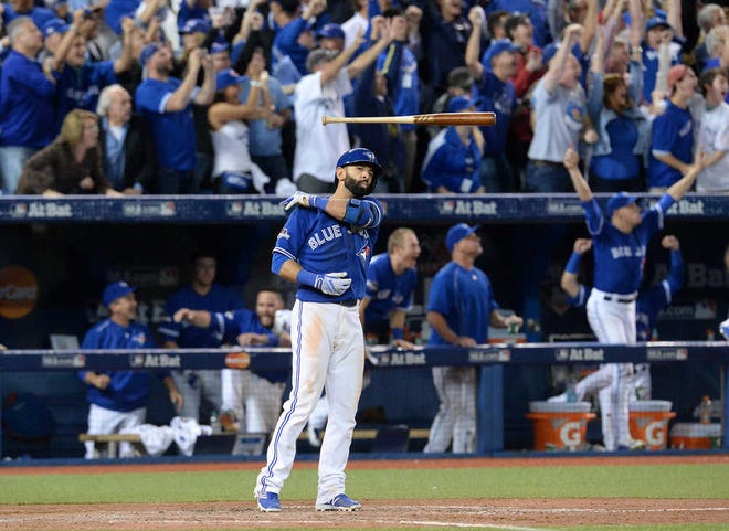 Toronto Blue Jays Jose Bautista flips his bat after hitting a three-run home run against the Texas Rangers during the seventh inning in Game 5 of baseball's American League Division Series, Wednesday, Oct. 14, 2015 in Toronto. (Chris Young/The Canadian Press via AP) MANDATORY CREDIT