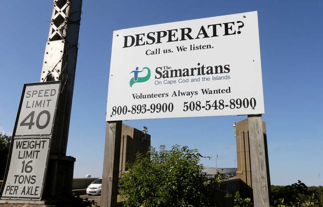 A sign for The Samaritans on Cape Cod and the Islands is posted near the Bourne Bridge, in Bourne, Mass., on Thursday, Oct. 8. For decades, Samaritans have offered phone counseling to the desperate and distraught. But increasingly Samaritans, Inc., based in Boston, is turning to text messaging to engage with young people.