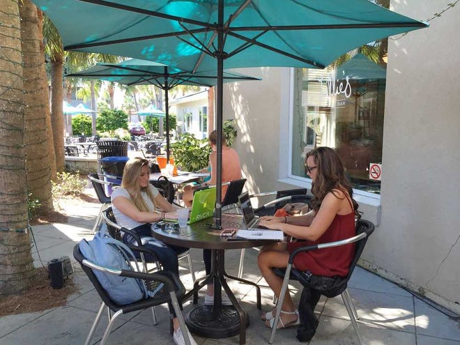 Brianna Mengel (left) and Sammy Walters study outside Lillie's Coffee Bar in Neptune Beach.