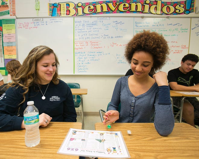 Forest High School students Rosa Robinson, left a senior and Kaela Parker, right, a 10th grader, play a game called "Getting to Know You," an intermediate Spanish conversation game in Deborah Paschke's Spanish II class, Thursday morning.