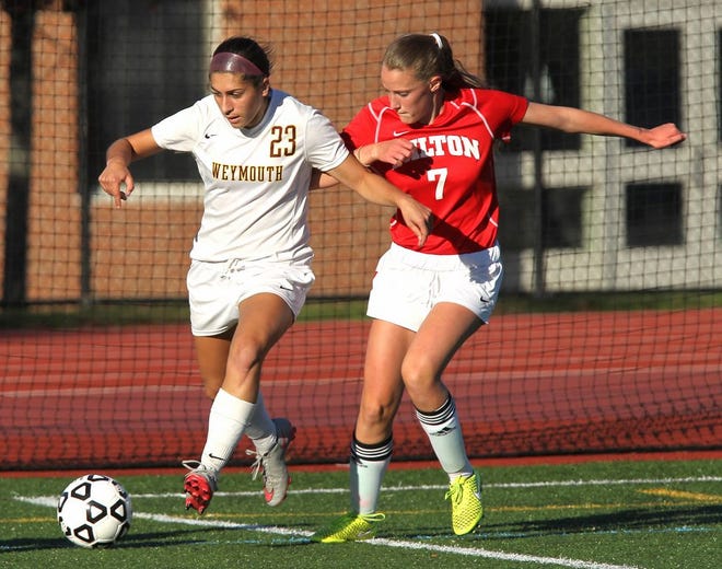 Weymouth's Ally Reynolds shields Milton's Laura Donelan from the ball. Weymouth hosted Milton in high school girls soccer, Thursday, Oct. 15, 2015.