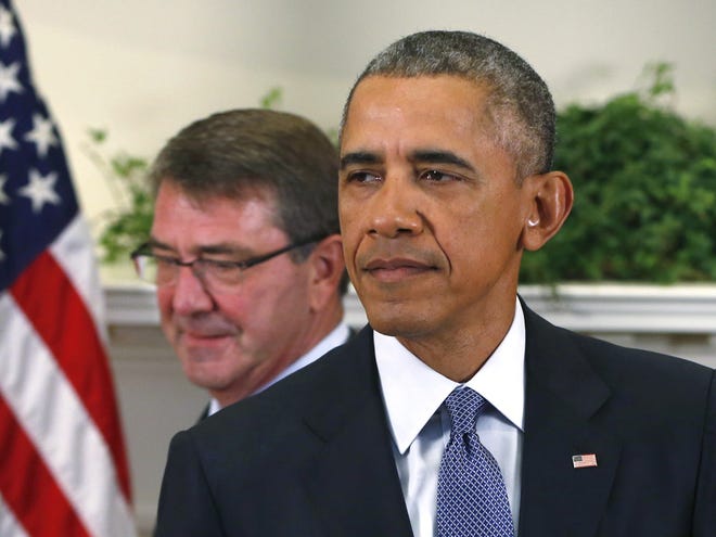 President Barack Obama, accompanied by Defense Secretary Ash Carter, arrives in the Roosevelt Room of the White House in Washington on Thursday to announce that he will keep U.S. troops in Afghanistan when he leaves office in 2017.