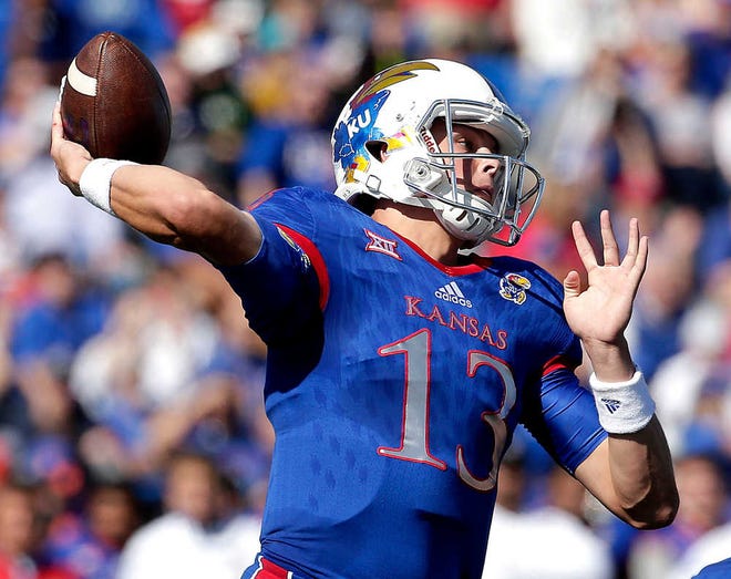 Kansas quarterback Ryan Willis (13) passes during the first half of an NCAA college football game against Baylor Saturday, Oct. 10, 2015, in Lawrence, Kan. Baylor won 66-7. (AP Photo/Charlie Riedel)