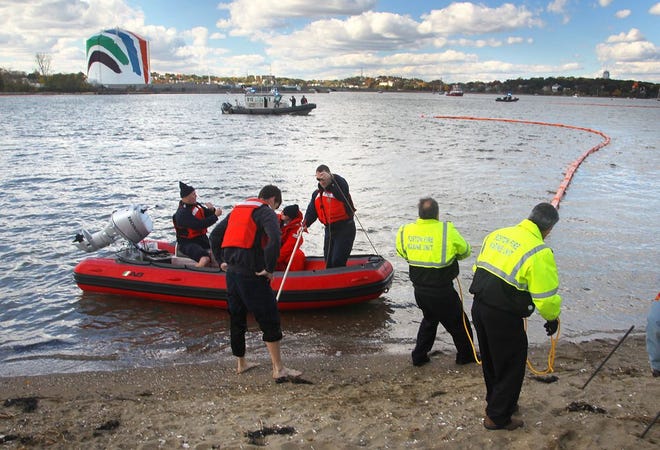 The cities of Boston and Quincy hosted a training exercise in the Neponset River near Squantum Point Park on Friday, Oct. 16, 2015, to prepare the metropolitan Boston region for a possible oil spill or hazardous-material incident. As part of the drill, a containment boom was deployed by personnel working on shore and on the water..
