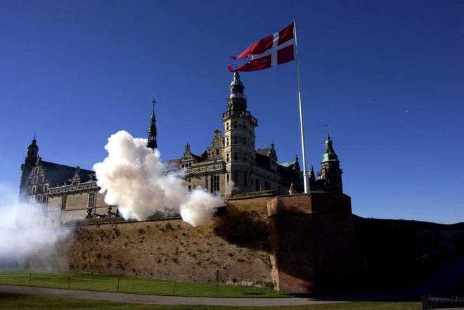 FILE - A Saturday Oct. 15, 2005 photo from files of a 21 canon salute at Kronborg Castle in Helsingoer, about 50 kms (30 miles) north of Copenhagen, Denmark, made famous as Elsinore in Shakespeare's play "Hamlet". Danes were excited this week to see their calm and prosperous country thrust into the U.S. presidential race as Democratic hopefuls Bernie Sanders and Hillary Clinton sparred over whether there's something Americans can learn from Denmark's social model. (Kim Agersten/Polfoto via AP, File) DENMARK OUT