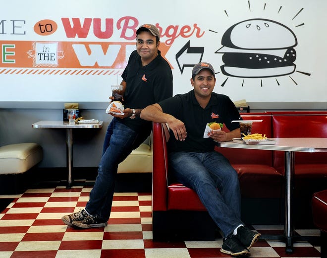 WuBurger co-owners Kal Gullapalli (left) and Deepak Diwan stop for a photo in the retro burger restaurant Oct. 9.

Wicked Local Staff Photo/David Gordon