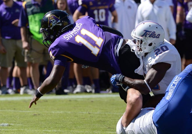 East Carolina quarterback James Summers (11) fights for yardage while Tulsa's Zik Asiegbu (20) works to bring him down in Saturday's game in Greenville.