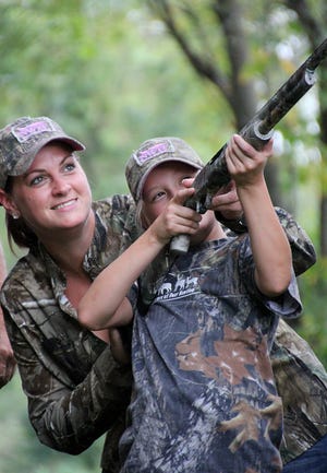 Sherri Polhamus and her daughter Kaci, 10, share a hands-on lesson in dove hunting at Torstenson Youth Conservation Education Center. KIMBERLY WATLEY/CORRESPONDENT/RRSTAR.COM