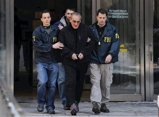 In this Jan. 23, 2014 file photo, FBI agents flank Vincent Asaro as they escort the reputed mobster from FBI offices in New York. More than 30 years after one of the largest cash robberies in U.S. history, the now 80-year-old Asaro will stand trial in New York for helping to plan the heist that became immortalized in the Martin Scorsese mob movie "Goodfellas." (Charles Eckert/Newsday, via AP, File)