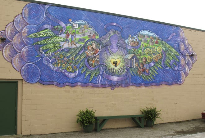 A mural covers the wall of a store in Rutland, Vt., commemorating the life of 17-year-old Carly Ferro, a star athlete, who was hit by a car and killed while leaving her job at the store. The Associated Press