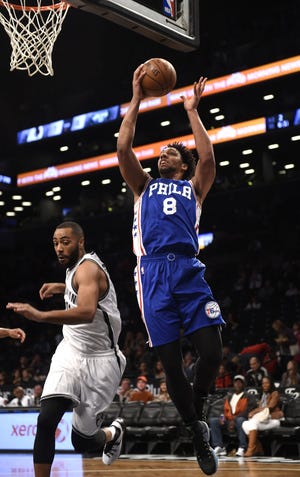 Sixers center Jahlil Okafor (8) drives to the basket over Nets guard Wayne Ellington (21) during Sunday's game in Brooklyn.