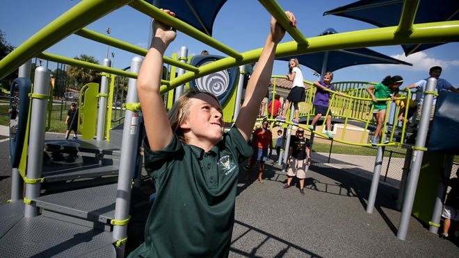 Marsh Pointe Elementary fifth-grader Luke Sittler, 11, enjoys the new playground inside Mirasol Park in Palm Beach Gardens on Oct. 14, 2015. (Richard Graulich / The Palm Beach Post)