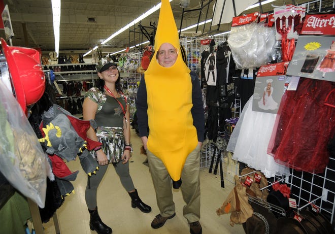 Jennifer Moore, left, dressed as a military person and Robert Mann enjoy the Halloween section at the Savers on Lincoln St. T&G Staff/Christine Peterson
