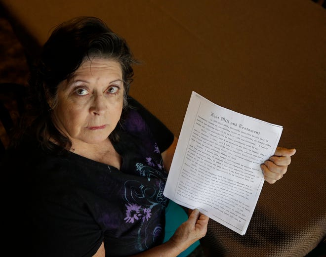 In this Tuesday, Sept. 22, 2015 photo, Mary Ann Steele, of Carmichael, Calif., holds a copy of a will which is part of a lawsuit against the state of California in her efforts to reclaim an inheritance from her adoptive father. States have taken control of over $40 billion from Americans forgotten bank accounts, uncashed paychecks and unclaimed life insurance payouts, that most Americans don't know they are entitled to. Steele received checks totaling a little over $68 front the state, from the inheritance, but she believes she is entitled to far more. (AP Photo/Rich Pedroncelli)