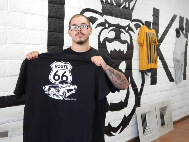 Eric Badham Jr. holds up a T-shirt he created for the Barstow Chamber of Commerce in preparation for the Route 66 Festival held over the weekend. Badham is the owner of Cali King Custom Clothing and Visual Productions, which recently celebrated its grand opening. Badham’s shop, located at 967 Armory Road, offers custom screen printed T-shirts, specialty brand clothing, custom vinyl decals and even photography and video production. Jose Quintero, Desert Dispatch