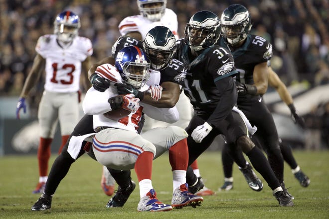 New York Giants running back Andre Williams is tackled by Philadelphia Eagles inside linebacker DeMeco Ryans during the first half Monday, Oct. 19, 2015, in Philadelphia.