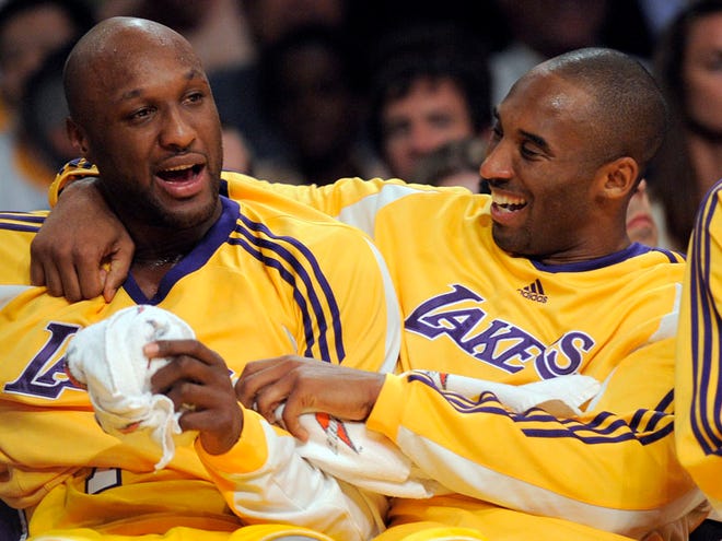 In this Nov. 18, 2008, file photo, Los Angeles Lakers guard Kobe Bryant, right, talks with forward Lamar Odom after Odom fouled out against the Chicago Bulls during the second half of their NBA basketball game in Los Angeles. Odom, who was embraced by teammates and television fans alike for his Everyman approach to fame, was found face-down and alone Tuesday, Oct. 13, 2015, after spending four days at the Love Ranch, a legal Nevada brothel.