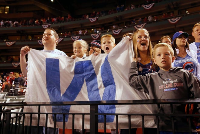 Cubs fans display a 'W' flag Oct. 10 at Busch Stadium after Chicago beat the St. Louis Cardinals 6-3 in Game Two of the National League Division Series. CHARLES REX ARBOGAST/THE ASSOCIATED PRESS
