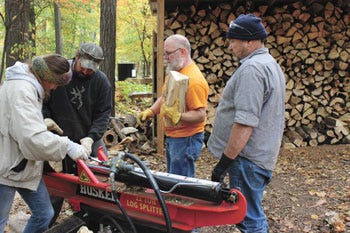 Volunteers from the Sturgis Eagles Club gathered Saturday for its twice-a-year day of community service at Camp Fort Hill. Running a log splitter and stacking wood were Angela Probst, Bill Croy and Ron Probst. Also lending a hand was Joey Slone.