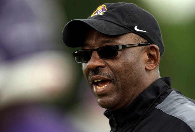 ECU head coach Ruffin McNeill talks to players at a Pirates' practice.