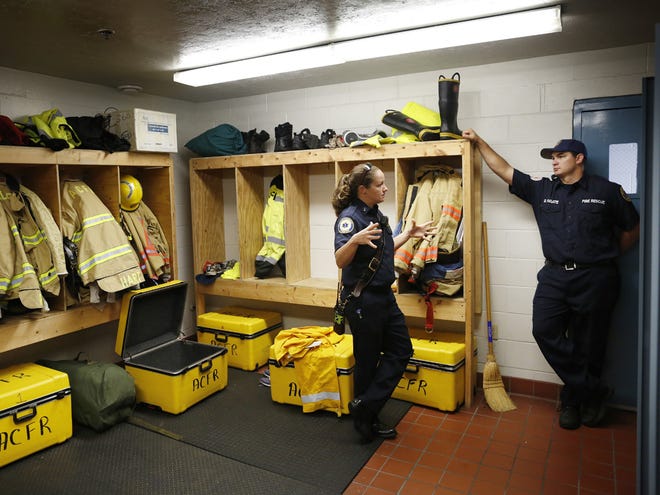 Alachua County Fire Rescue Lt. Misty Woods and firefighter/EMT Duane Fugate III are pictured in a gear storage room at Station 19.