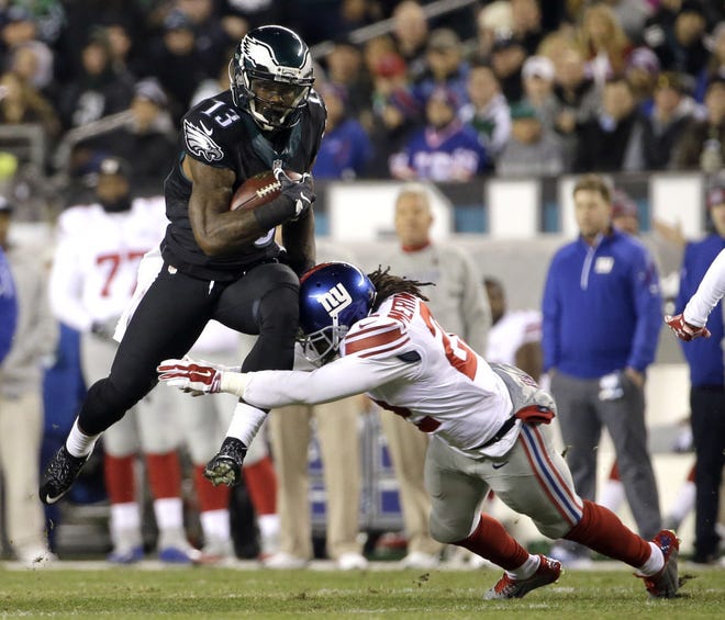 Philadelphia Eagles wide receiver Josh Huff tries to avoid a hit by New York Giants strong safety Brandon Meriweather during the first half Monday, Oct. 19, 2015, in Philadelphia.