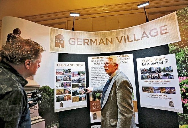 Russ Arledge, curator of archives and facilities for the German Village Society, points to a display about the neighborhood that he put together. The display, the first in what is hoped to be a series, will remain near the entrance to City Hall for several months.
