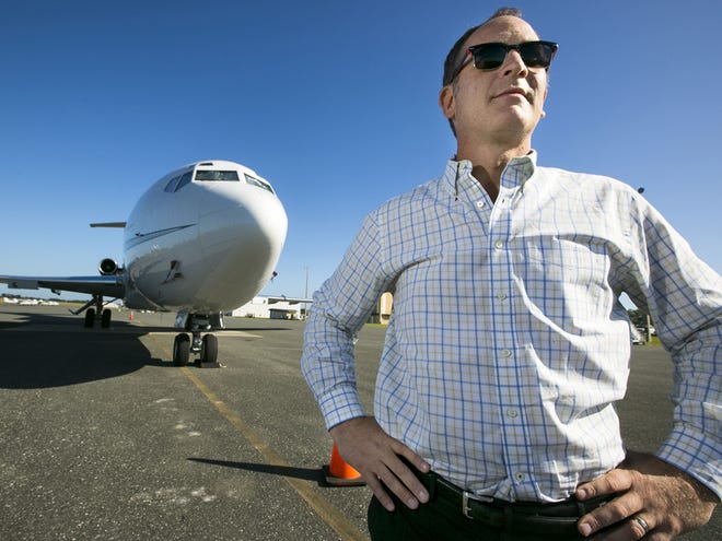 Airport Director Matt Grow is shown with a privately owned Boeing 727 that is stationed at the Ocala International Airport on Tuesday.