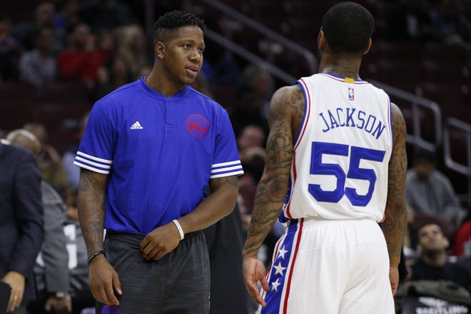 Sixers guard Isaiah Canaan, left, gives advice to teammate Pierre Jackson (55) during the second half of Friday's preseason game against the Wizards.
