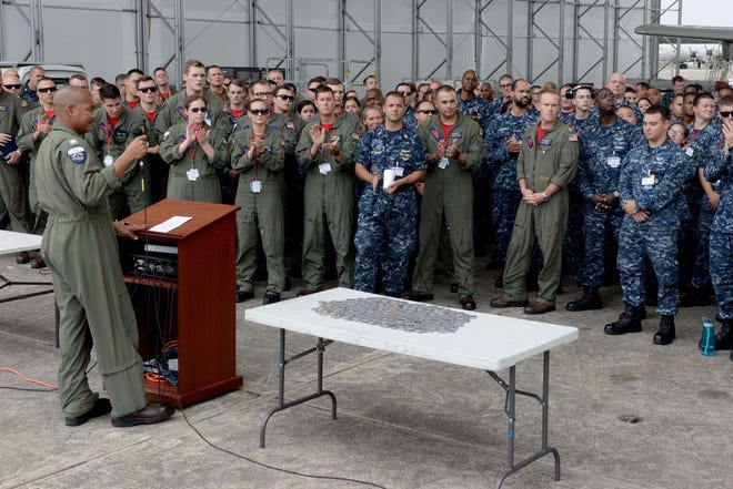 VP-10 Commanding Officer Cmdr. Herbert Lacy recently addressed the "Red Lancers" during quarters in their temporary hangar at Cecil Airport - and congratulated them on achieving success during the safe for flight event.