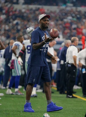 Dallas Cowboys' Dez Bryant watches from the sideline during the first half of an NFL football game against the New England Patriots, Sunday, Oct. 11, 2015, in Arlington, Texas. (AP Photo/Brandon Wade)