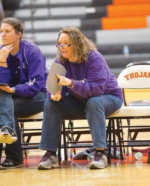 Bronson volleyball coach Jean LaClair signals in where she wants a ball served during play last weekend at Thornapple-Kellogg as assistant coach Brooke Pyles looks on.