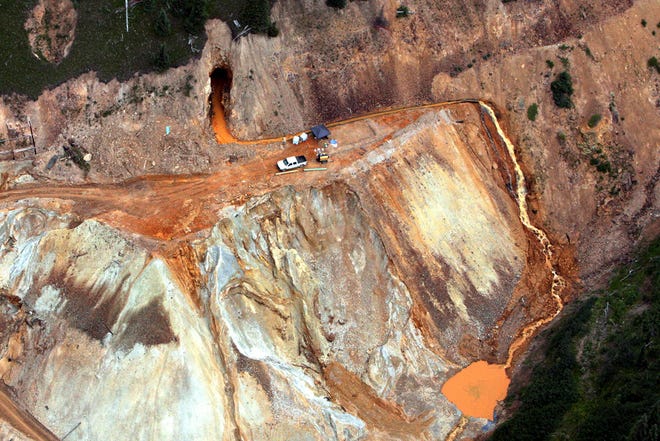 This Aug. 11, 2015, file photo shows waste water continuing to stream out of the Gold King Mine near Silverton, Colo. Government investigators squarely blamed the U.S. Environmental Protection Agency Thursday, Oct. 22, 2015 for a 3 million gallon wastewater spill from a Colorado gold mine, saying an EPA cleanup crew rushed its work and failed to consider the complex engineering involved, triggering the very blowout it hoped to avoid. (Geoff Liesik/The Deseret News via AP, file)