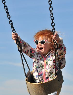 Flying high in the sky at Pennington Park in Delanco, Eliora Wilcox, 2, of Delanco, enjoys her ride on the swings, Thursday, Oct. 22, 2105.